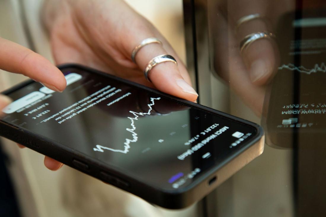 A woman checking ETF prices on her phone