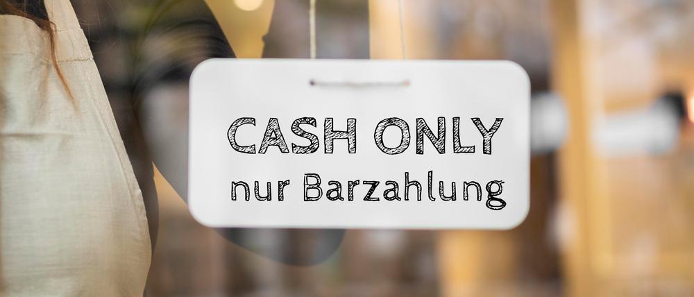 Sign indicating Cash Only Nur Barzahlung at a shop entrance