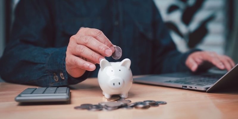 Person saving money in piggy bank symbolizing pension savings growth