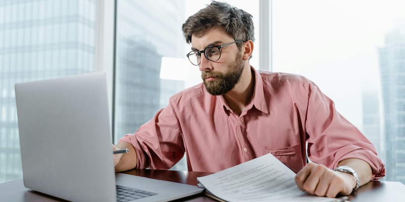 A businessman on a laptop deep in financial planning - symbol and article image on the topic of operating credit