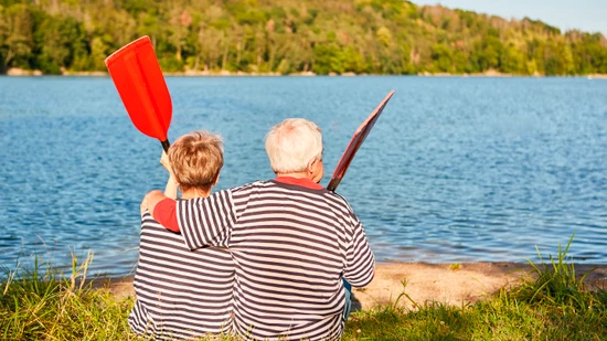 An elderly couple sitting peacefully, representing the aging demographic and pension income factors
