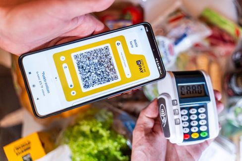 A QR code on a payment terminal signals the shift toward digital receipts in Germany