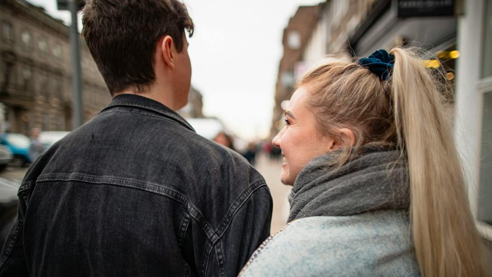 A couple using an online calculator to compare renting versus buying costs, illustrating the financial calculations in the article.